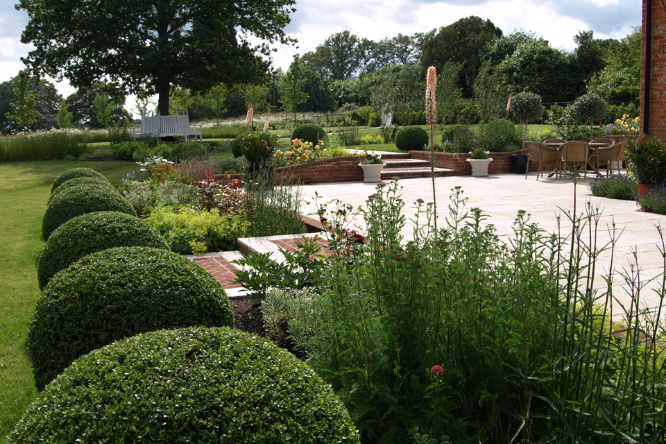 Bob Balls. Brick paving. Herbaceous borders. Steps. Tree seats.