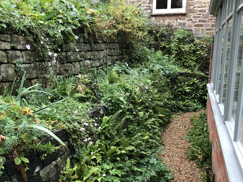 Stone wall beside conservatory