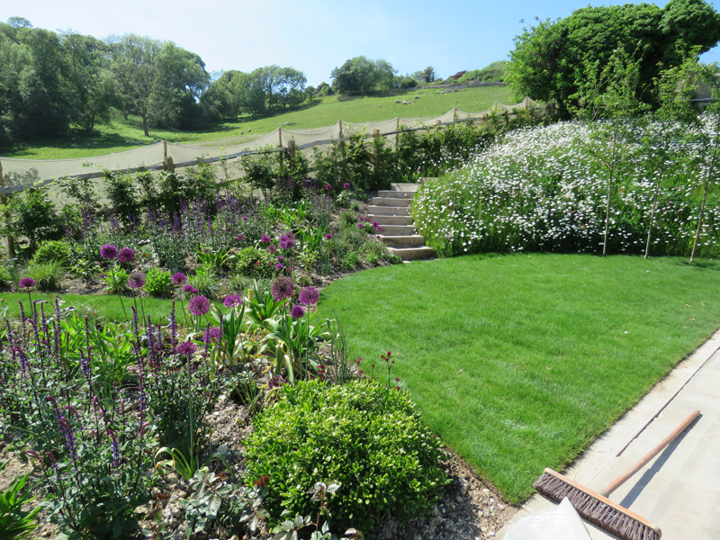 Grasses are interplanted with the herbaceous plants to extend the seasonal interest