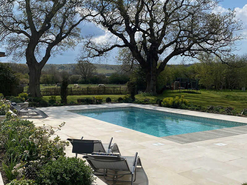 Oak trees. Swimming pool. Automatic cover. Pool design Sussex. Sussex Garden Design.
