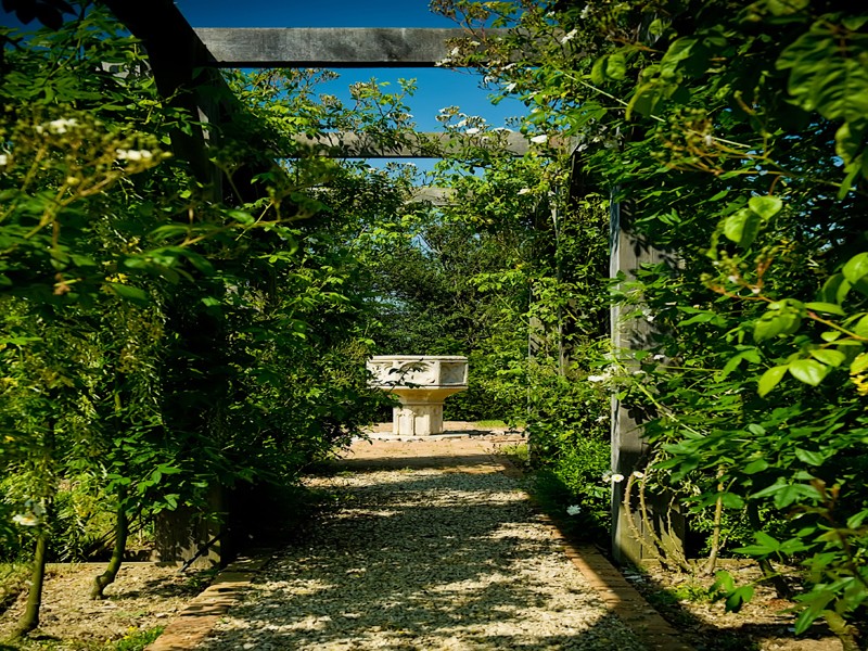 Central antique water feature/font through rose walkway