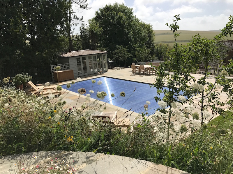 Looking from the top terrace down to the pool in summer